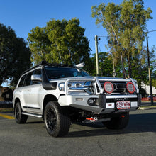 Load image into Gallery viewer, A white ARB Steel Flat Rack 87” X 44” for Toyota Land Cruiser 200 Series 2008 - 2021 parked on a street with secure storage.