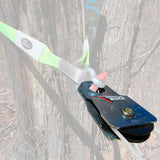 A green ARB Snatch Block 7000 - 30,000lb Breaking Strength ARB2091A attached to the side of a tree, featuring a carrying capacity for wind noise reduction.