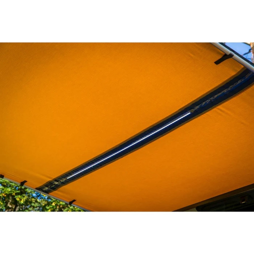 A ARB Touring Awning with Light 814410 with a blue stripe.