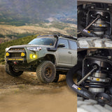 An off-road performance Old Man Emu Toyota 4Runner gracefully maneuvers on a dirt road with its adjustable damping and OME BP-51 shock absorbers.