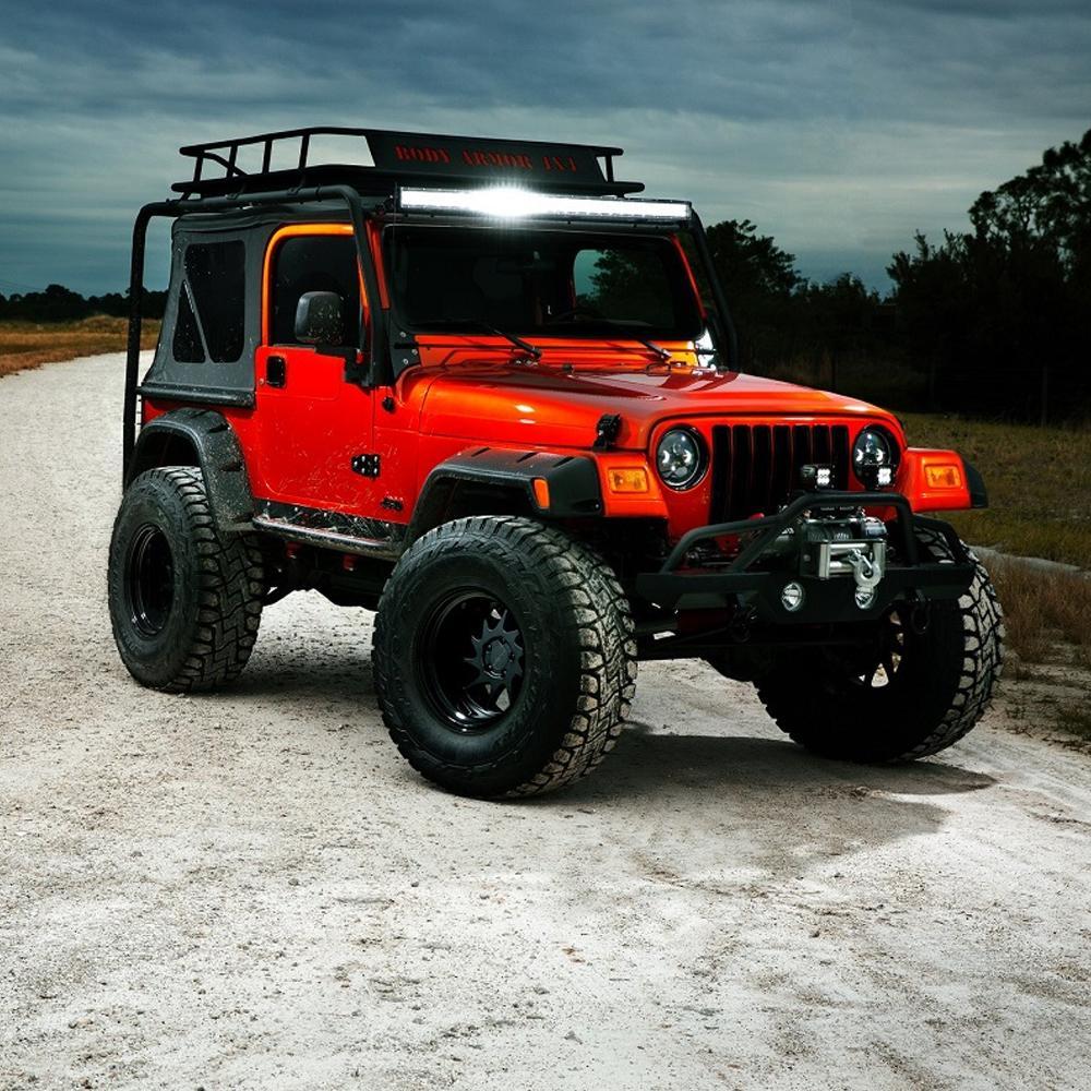 A rugged orange jeep is parked on a dirt road, showcasing its ARB RD105 Air Locker Differential Dana 35 with 30 Splines.