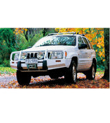 An Old Man Emu white Jeep Grand Cherokee WJ & WG (2005-2010) - V8 PETROL & DIESEL with easy installation and ride height increased parked among the autumn leaves.