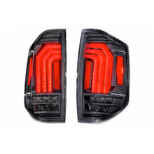 Load image into Gallery viewer, Enhance the performance of your Ford F-150 with these black and red tail lights, designed to perfectly complement the Morimoto XB LED Tails LF705 for Toyota Tundra (2014 - 2021). Upgrade your truck&#39;s style and visibility with this Morimoto product.