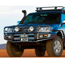 Load image into Gallery viewer, A blue Old Man Emu Toyota Land Cruiser with exceptional suspension performance is parked in the desert.