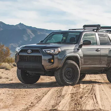 Load image into Gallery viewer, The 2019 Fox Racing Toyota 4Runner, known for its durability, is parked on a dirt road.