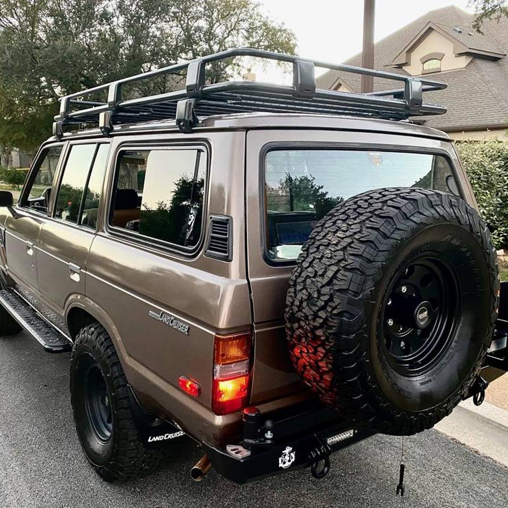 An ARB SUV with an ARB Roof Rack Fitting Kit 3700060 (43”x44”) on the back.
