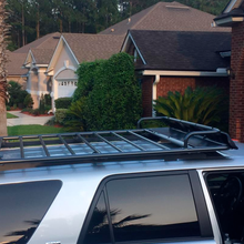 Load image into Gallery viewer, An ARB Touring Roof Rack FJ Cruiser (2007-2009) 3800200KLC2, equipped with a roof rack, is parked in front of a house.