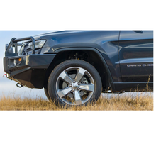Load image into Gallery viewer, The front end of a blue Jeep Grand Cherokee featuring the ARB Old Man Emu Rear Nitrocharger Sport 60088 with heavy gauge reserve tube and high-quality oil.