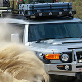 A Toyota FJ Cruiser with exceptional suspension, including Old Man Emu BP-51 shock absorbers, effortlessly navigates through sand.