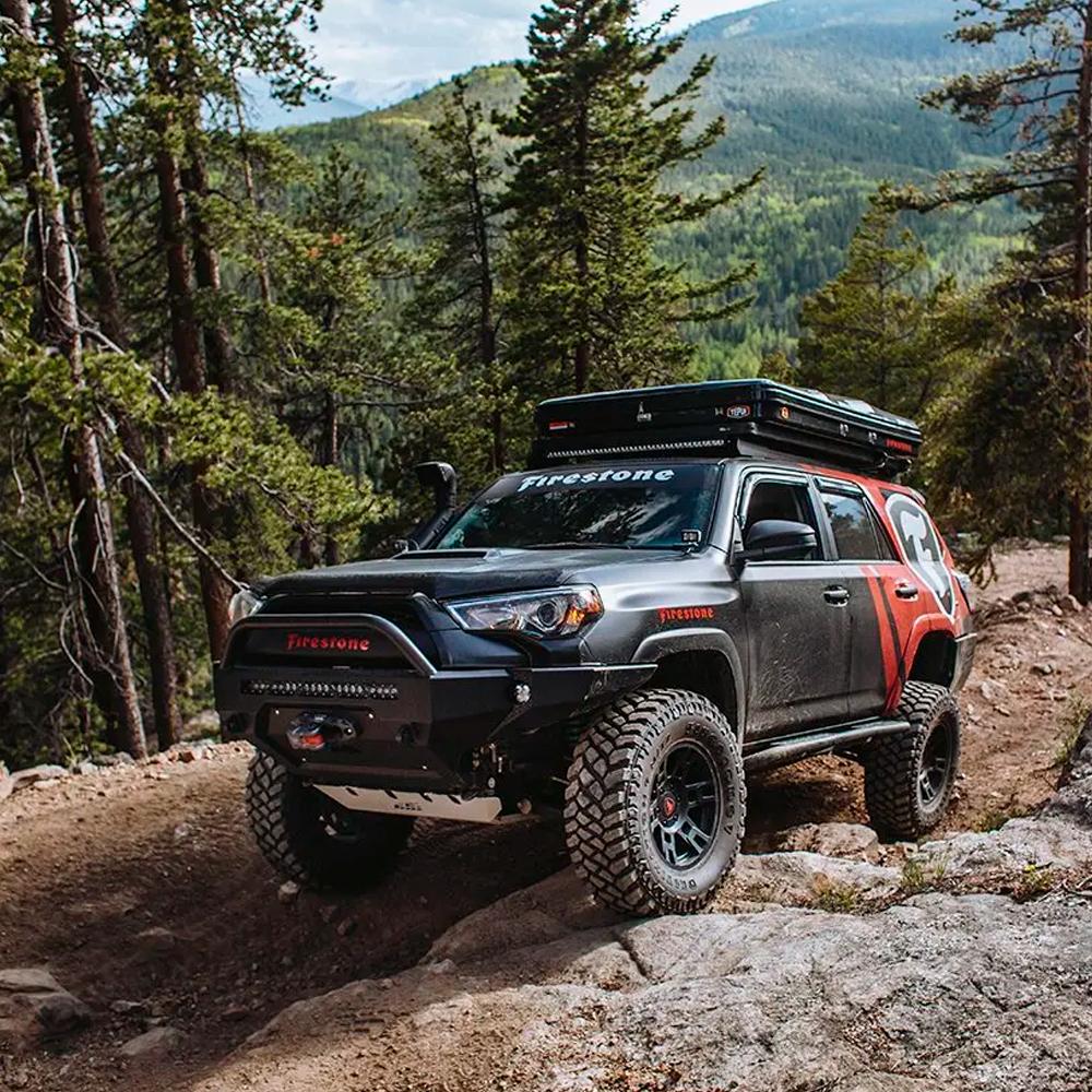 The installation of the ARB Old Man Emu Rear Coil Springs 2895 on a Toyota 4Runner has increased its ride height, making it perfect for navigating through the rocky trail.