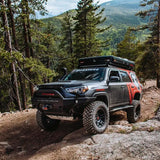 The installation of the ARB Old Man Emu Rear Coil Springs 2895 on a Toyota 4Runner has increased its ride height, making it perfect for navigating through the rocky trail.