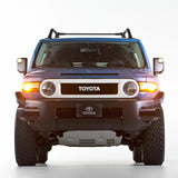 The front end of a blue Toyota FJ Cruiser equipped with the OME BP-51 2.5 - 3 inch Lift Kit for FJ Cruiser (10-ON) from Old Man Emu suspension and shock absorbers.