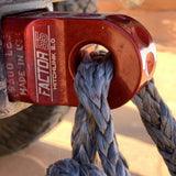 A red rope is attached to the back of a jeep using a Factor 55 HitchLink 2.0in Red 00020-01.