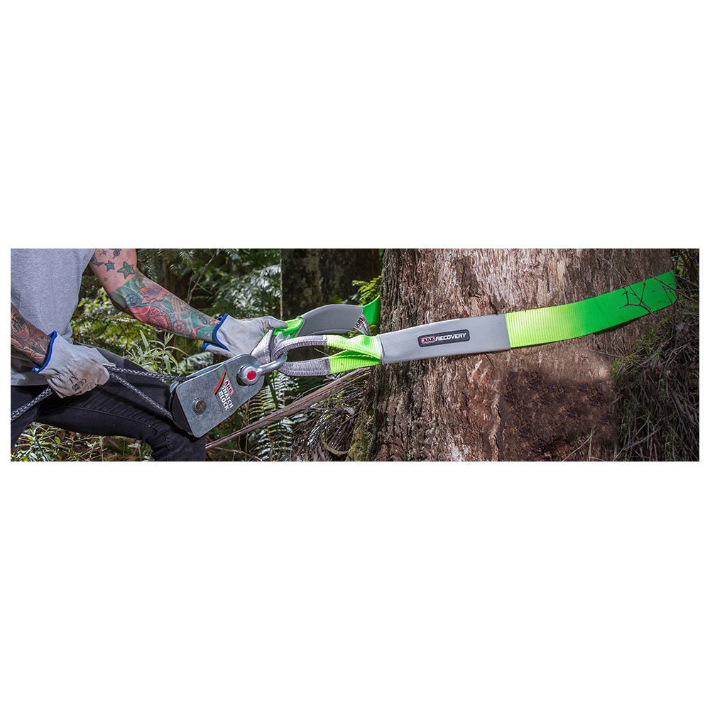 An individual using a chainsaw to cut down a tree, ensuring the proper anchor point and utilizing ARB Tree Protector - 10ft ARB730LB for added safety.