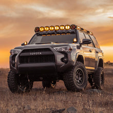 Load image into Gallery viewer, The Old Man Emu Toyota 4Runner is parked in a field at sunset, offering easy installation and oxidation protection.