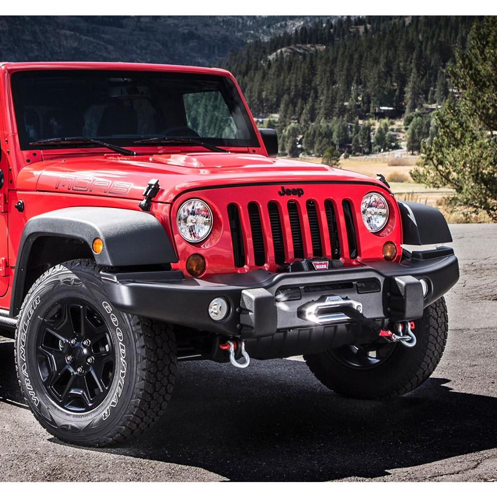 The red Old Man Emu jeep wrangler, equipped with the ARB Old Man Emu Front Nitrocharger Sport Shock Absorber 60160, is parked in front of a mountain.