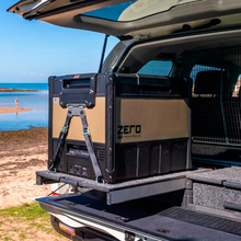 Load image into Gallery viewer, A durable SUV with versatile cargo capacity features an ARB Zero 73 Quart Dual Zone Portable Fridge Freezer 10802692 in the trunk.