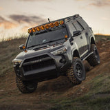 The Old Man Emu 4Runner, equipped with the OME BP-51 2-3 inch Lift Kit for 4Runner w/ KDSS (10-23), is driving down a dirt road with its efficient suspension system.