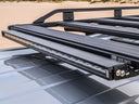 An ARB car with an ARB Slimline Roof Rack Light 1780500 on top of it, featuring a polycarbonate lens and reflector design for optimal lighting.