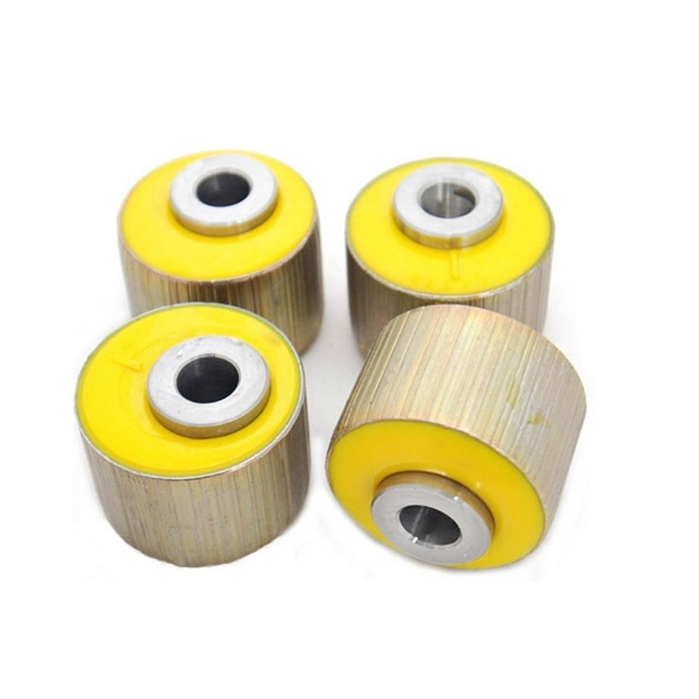Four yellow Old Man Emu rubber bushings from the 4X4 suspension brand ARB, on a white background.