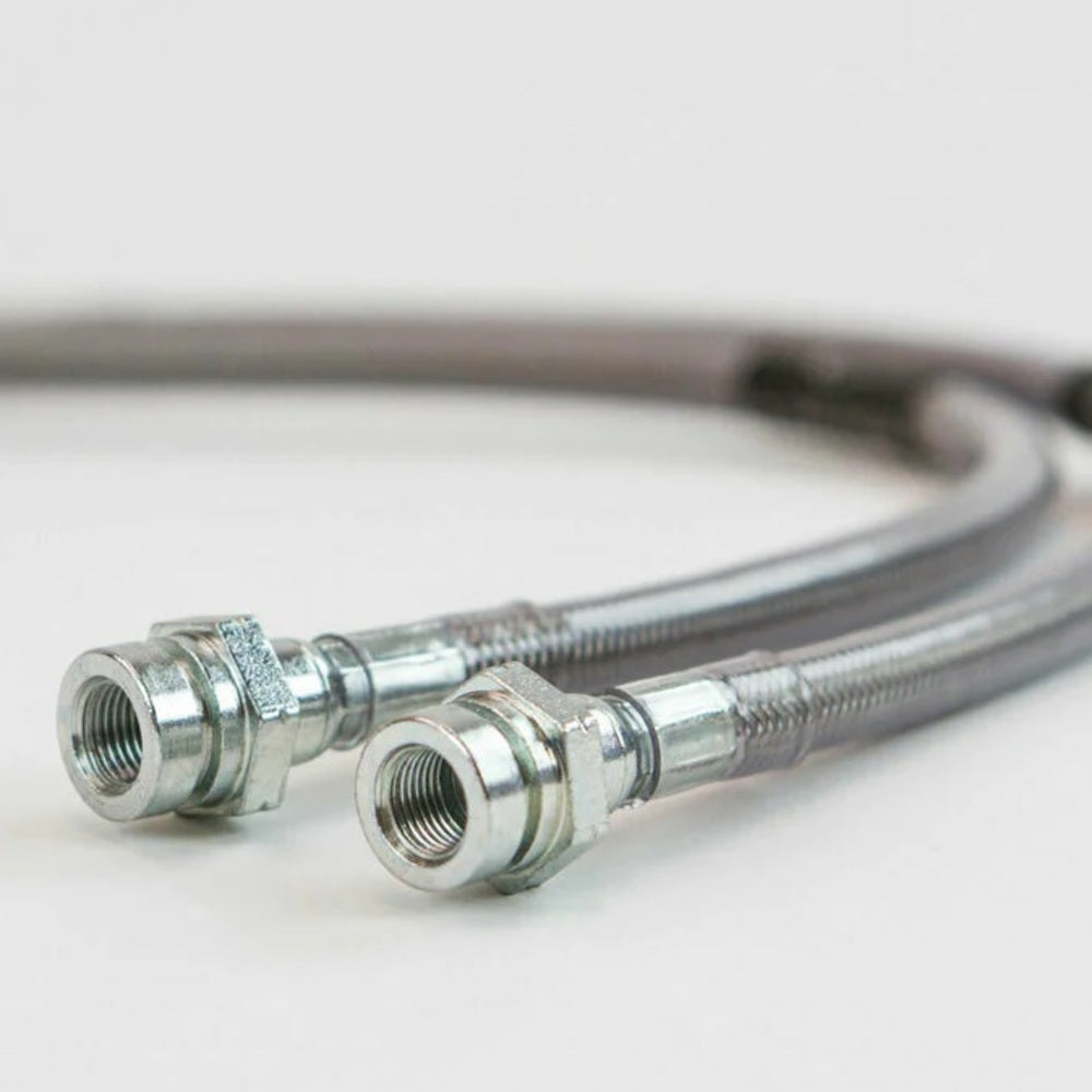 A pair of reliable and durable MetalTech Extended Rear Brake Lines for Toyota 4Runner and FJ Cruiser on a white surface.