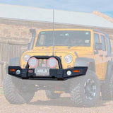 A yellow ARB Deluxe Bumper Combo Bar For Jeep Wrangler JK 2007-2023 ARB 3450240 with vehicle integration is parked in front of a barn.