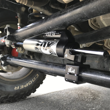 Load image into Gallery viewer, A picture of a Fox Racing suspension system, showcasing its control and ride quality.