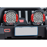 An ARB Intensity Solis 36 Flood Light SJB36F (individual) with adjustable bracket-mounted lights on the front bumper.