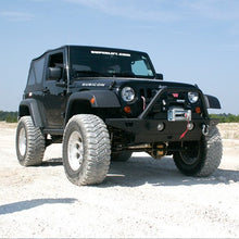 Load image into Gallery viewer, A black Fox Racing jeep parked on a dirt road, showcasing its increased ride height with the FOX 2 inch Jeep Wrangler JK 07-18 2Door Lift Kit (Standard Load) FOX Suspension FOXJK2D-0718 Fits 3rd Gen Jeep Wrangler JK  2 Door.
