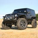 FOX 2 inch Jeep Wrangler JK (07-18) 2Door Lift Kit (Medium Load) FOX Suspension FOXJK2D-0718 installed on lifted black 2007-2018 Jeep Wrangler JK 2 Door Rubicon with off-road tires and aftermarket front bumper.