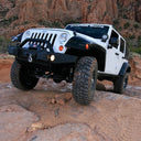 FOX 2 inch Jeep Wrangler JK (07-18) 4 Door Lift Kit (Standard Load) FOX Suspension installed on white 3rd Gen Jeep Wrangler JK 4 Door off-road