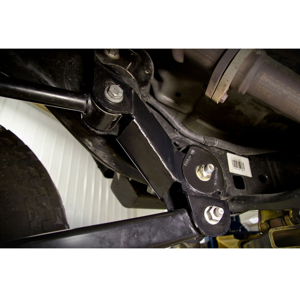 A detailed view of a vehicle's suspension system, showcasing the JKS Front Control Arm Correction Brackets for Jeep Wrangler JL and Gladiator JT and other suspension components.