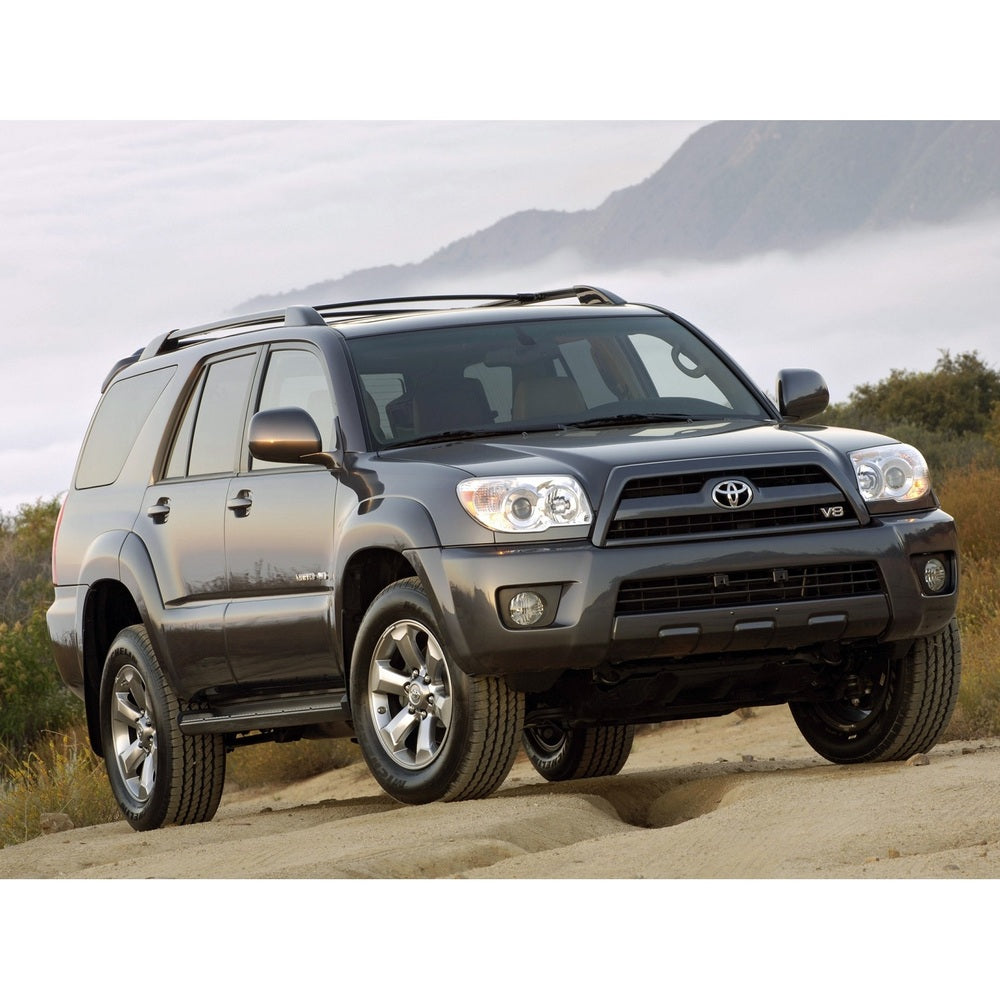 A gray Toyota 4Runner with exceptional off-road performance is driving on a dirt road, equipped with King Shocks' KING 0 - 2 inch Leveling Kit for 4Runner (03-09) for optimal damping characteristics.