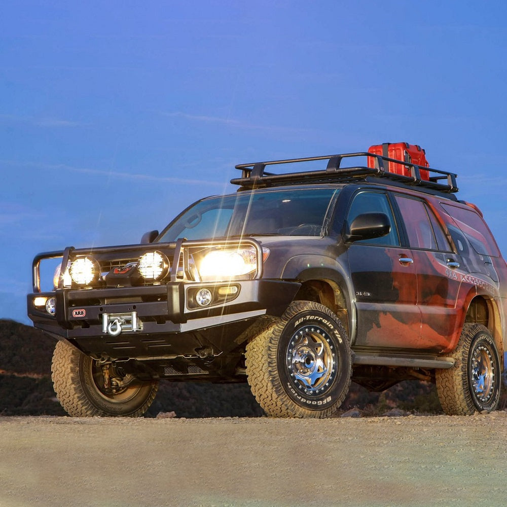 A Toyota Tacoma, equipped with King Shocks 0 - 2 inch Leveling Kit for 4Runner (03-09), is parked on a dirt road.