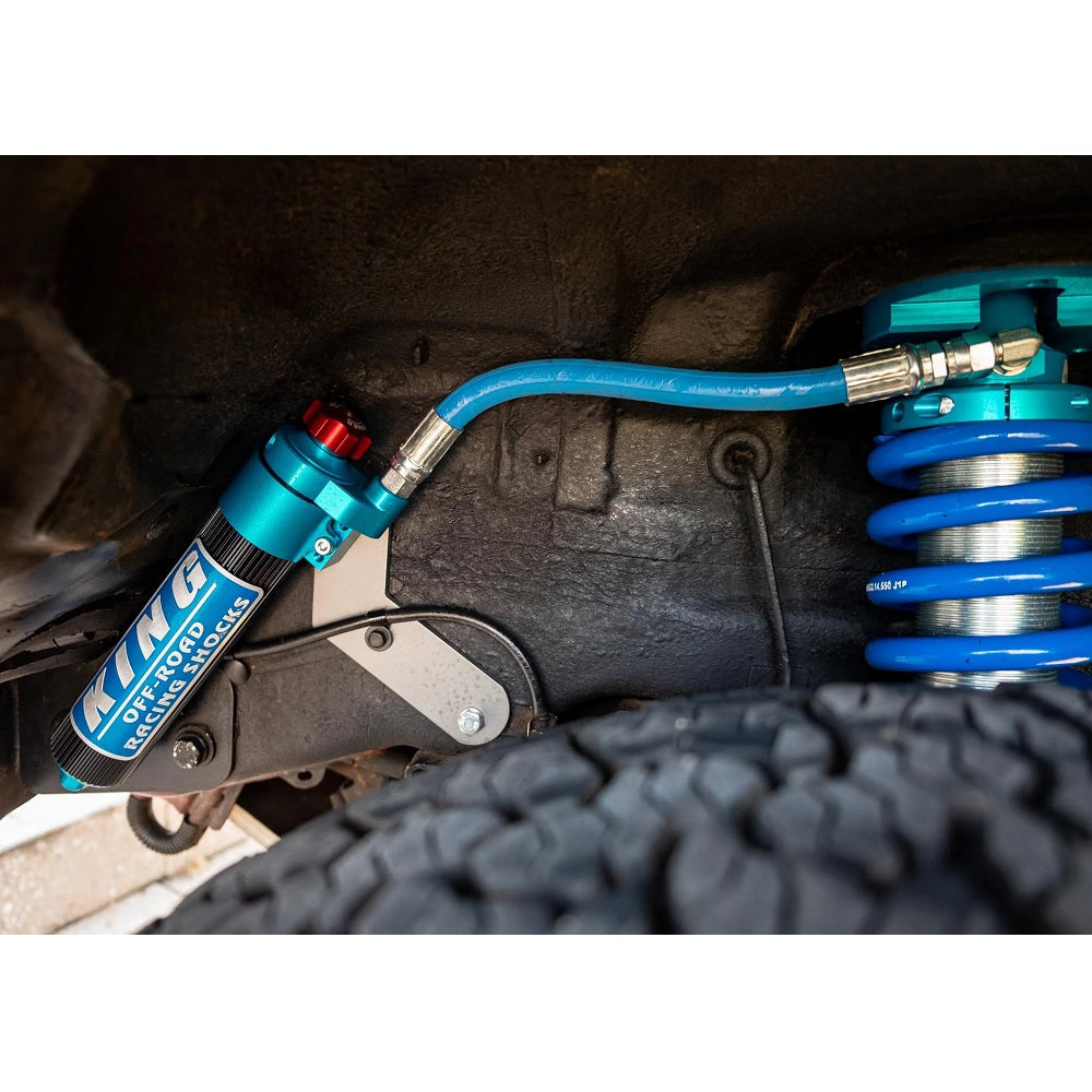 A KING 1.5 - 2 inch Lift Kit for LandCruiser 200 Series (08-21) produced by King Shocks is attached to the underside of a vehicle, enhancing its off-road performance.