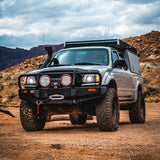 A King Shocks Tacoma with exceptional off-road performance and damping characteristics, parked in the desert.