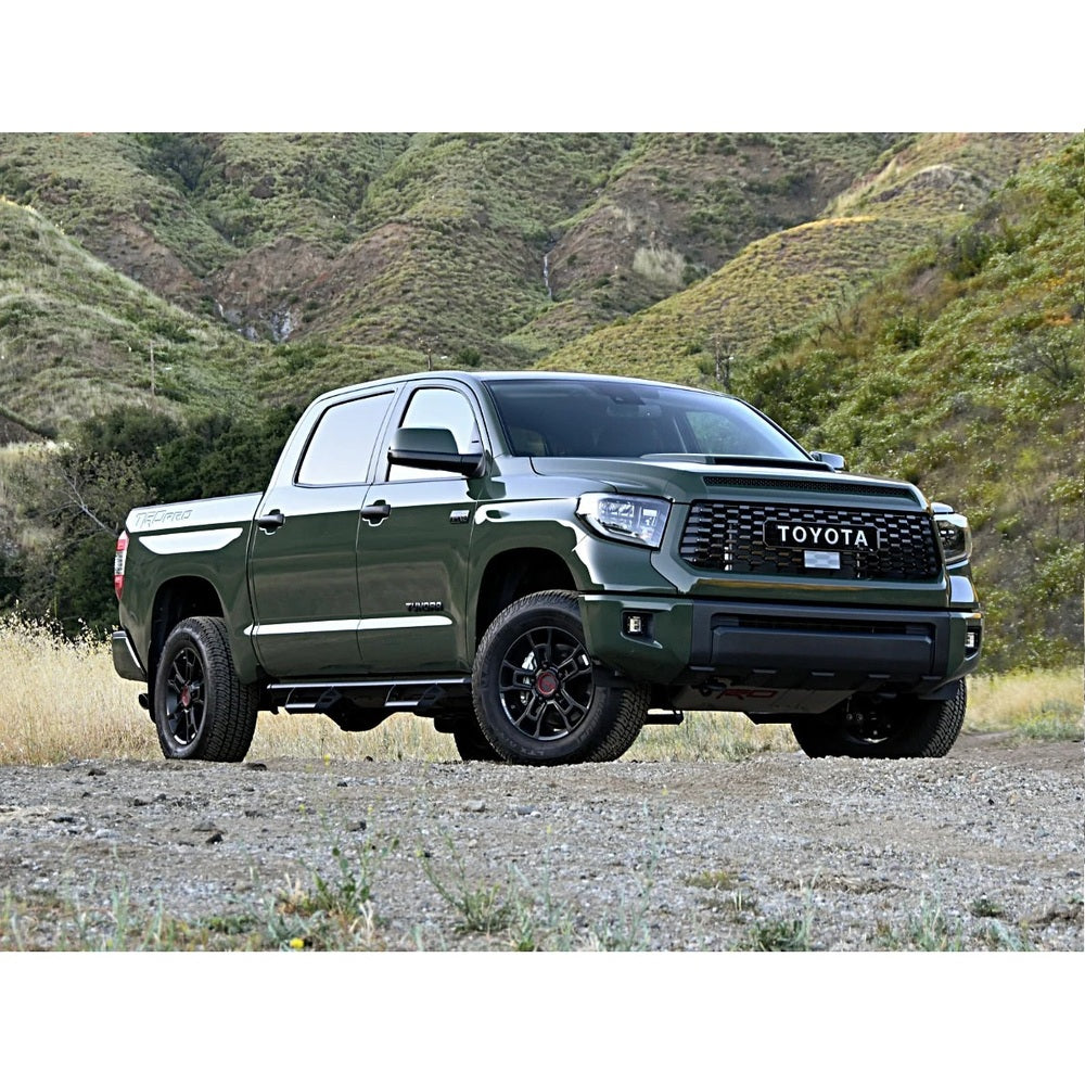 The 2019 Toyota Tundra, equipped with the KING 2 - 3 inch Lift Kit for Tundra (07-21) from King Shocks, is parked on a dirt road.