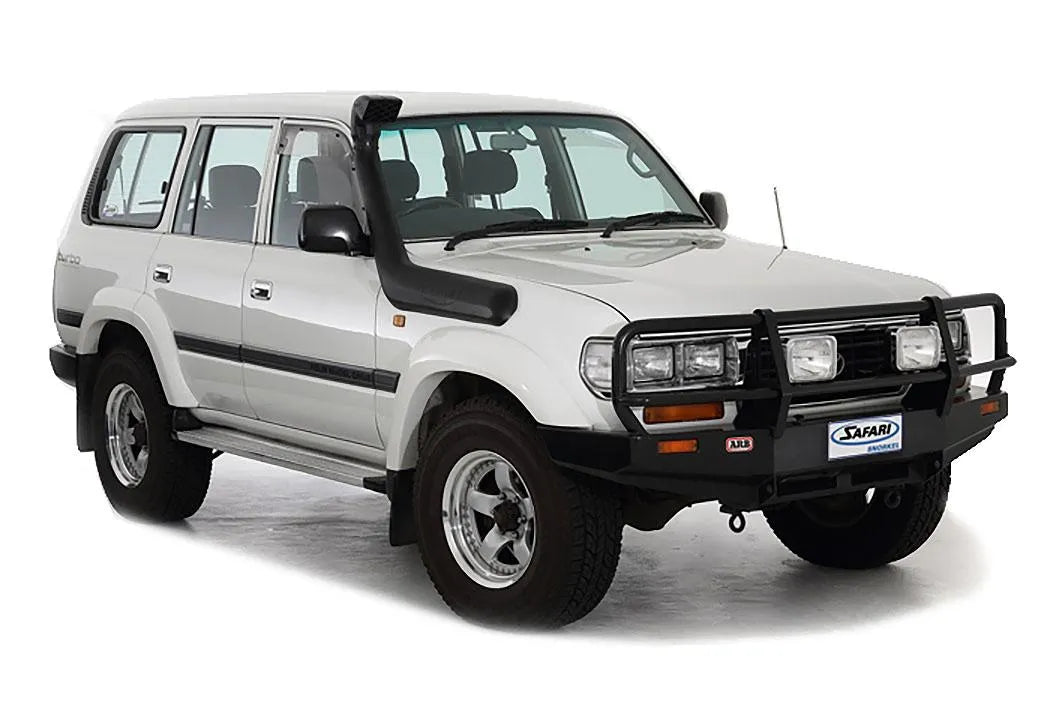 A white suv is parked on a Safari Snorkel Intake Kit Toyota Landcruiser 80 Series (1990-1997) ARB SS82R background.