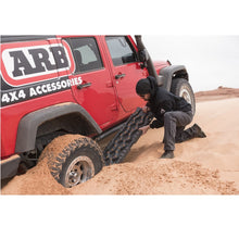 Load image into Gallery viewer, A jeep with ARB TRED Pro Recovery Boards TREDPROMGO - Gray/Orange providing excellent traction in the sandy landscape of Australia.