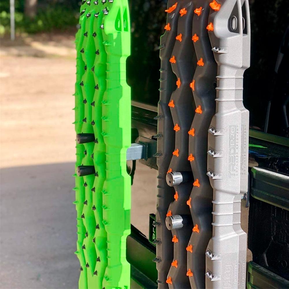 Two ARB TRED Pro Ratchet Handle TPMKRH ski racks with mounting brackets on the back of a truck.