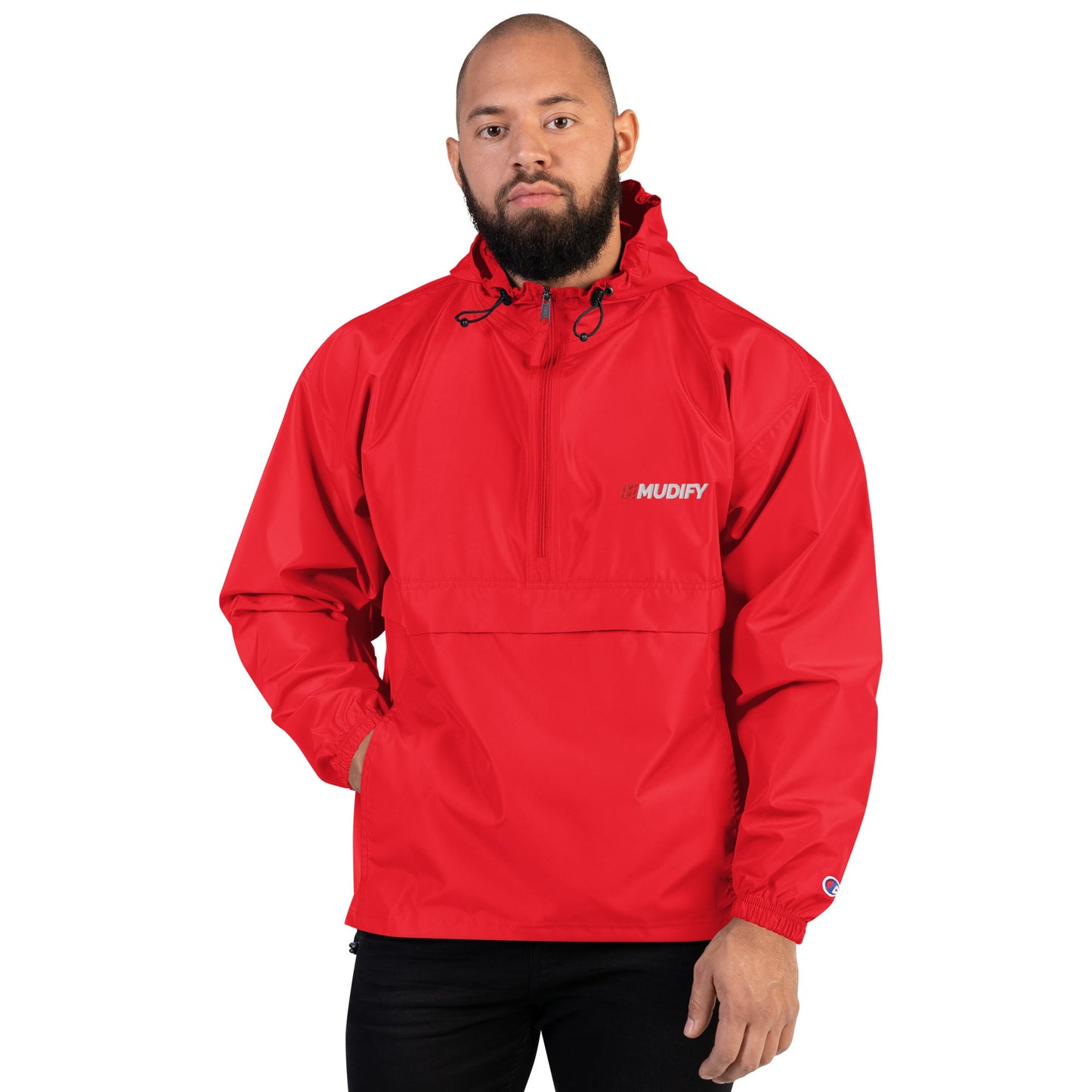 A man wearing a red Mudify Embroidered Packable Jacket.