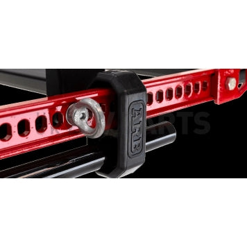 A black ARB HiLift Mount Base Rack Farm Jack Holder (Pair) 1780280 on a black background, ideal for ratchet straps.