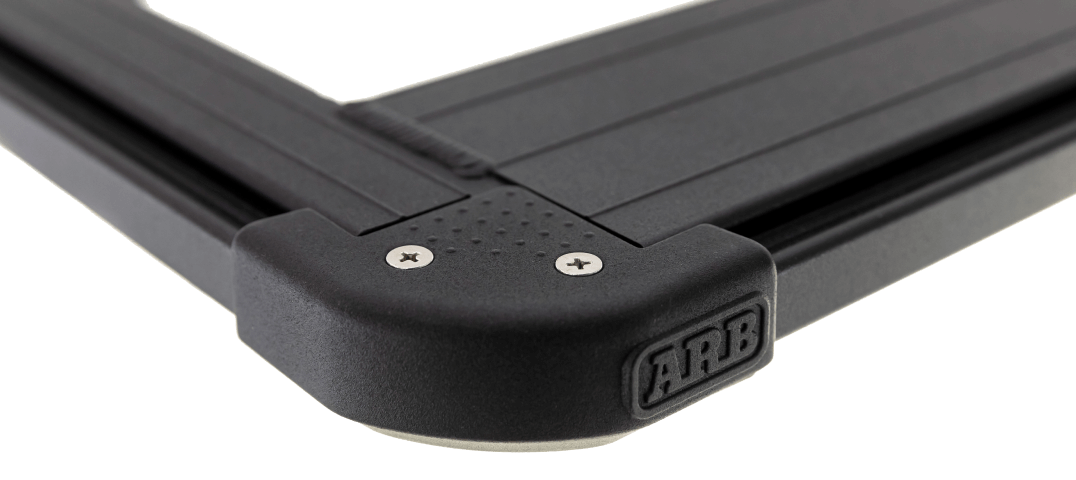 A black car with an ARB Base Rack (55" x 56") 1770070 and a dovetail system.