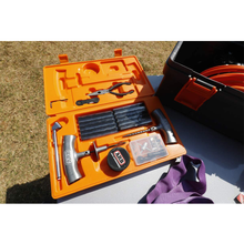 Load image into Gallery viewer, An ARB Speedy Seal Tire Repair Kit Series II 10000011 with an array of tools spread out on a table.