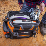 A man is holding an ARB bag full of ARB Premium Recovery Kit + Recovery Bag + Leather back gloves and more RK9A, specifically designed for small SUVs, containing a recovery kit tailored to the vehicle's weight.