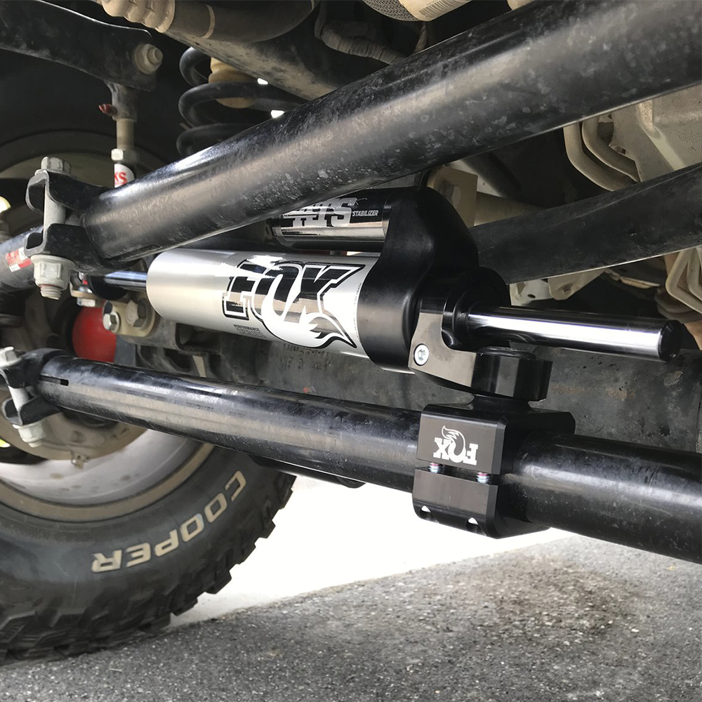A picture showcasing a Fox Racing suspension system on a vehicle, highlighting its enhanced ride quality and increased load-carrying capacity.
