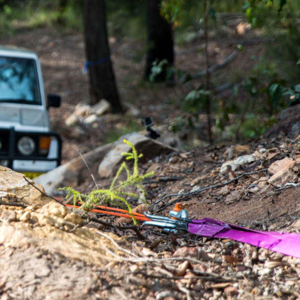 An ARB jeep is parked in the woods with an ARB Winch Extension Strap ARB725LB attached.
