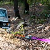 An ARB jeep is parked in the woods with an ARB Winch Extension Strap ARB725LB attached.