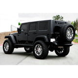 A black Old Man Emu Jeep Wrangler with Adjustable Front Upper Control Arms UCAJKFR is parked in a parking lot.