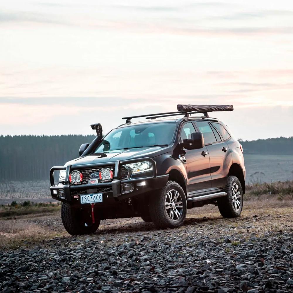 A black SUV, equipped with an ARB Air Fitting (R1 5 1/8") 170201, is parked on a gravel road.